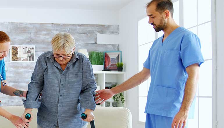 A carer helping a client with mobility support